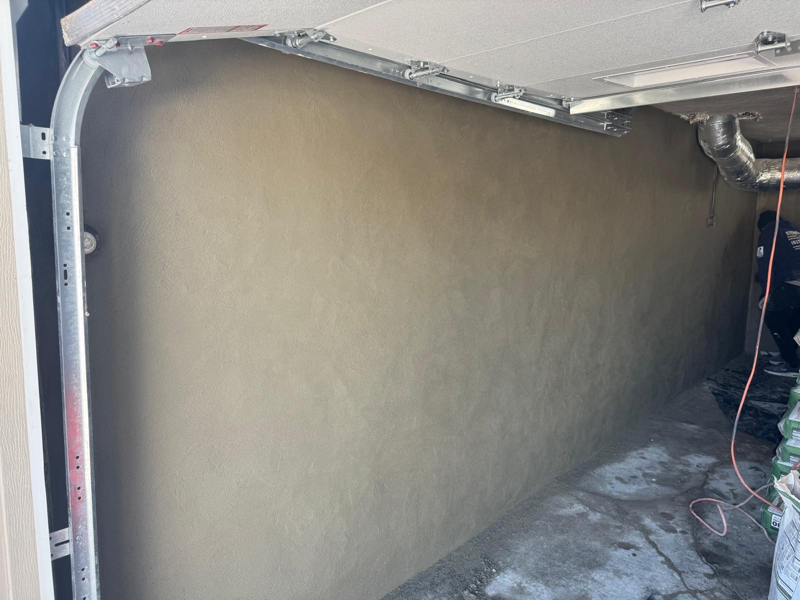 Garage wall stucco and damp-proofed