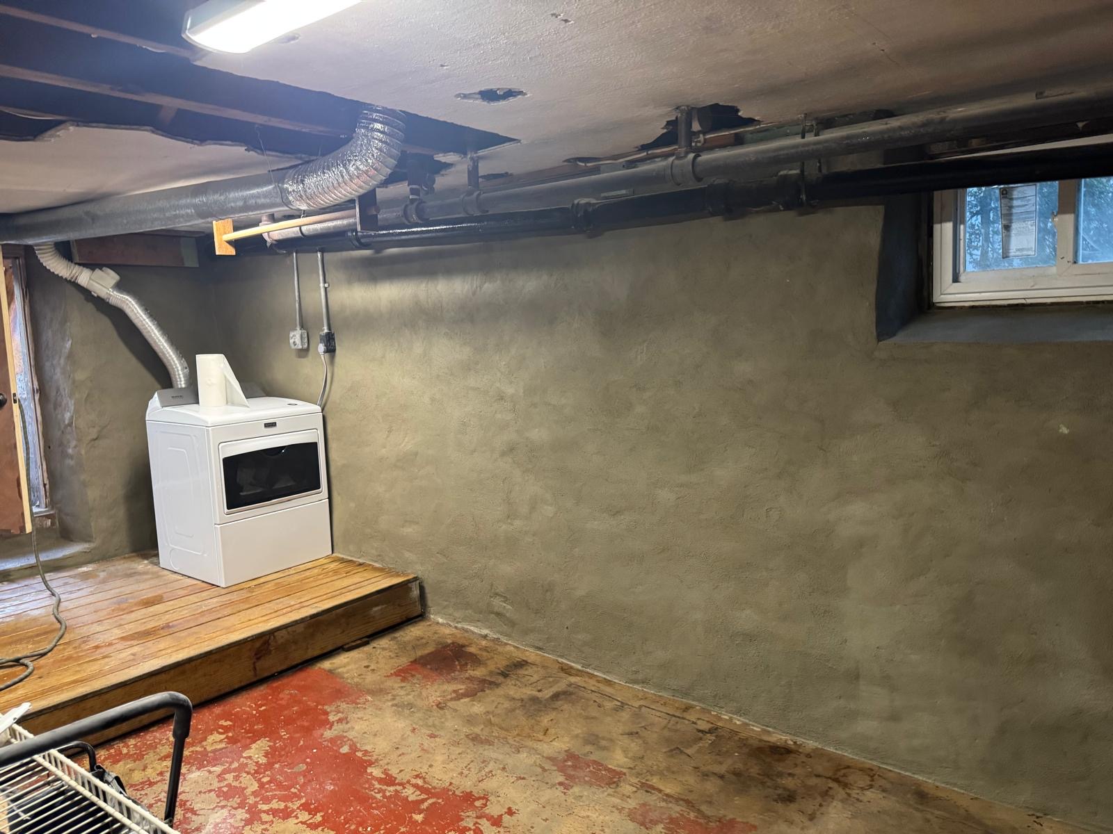 Basement wall parged and sealed against moisture